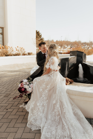 A couple dresses up in their wedding attire on their wedding day to take their romantic and natural documentary styled photos. Photographed by Hannah Lylene Photography.