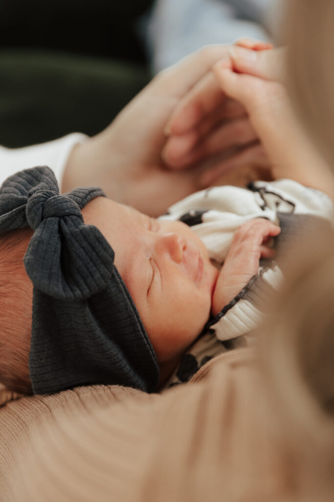 Details of a newborn baby&rsquo;s face while being held by their parents. Photography by Dallas Photographer Hannah Lylene Photography