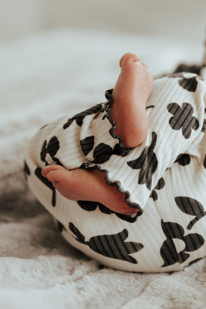 Details of a newborn baby&rsquo;s feet while being held by their parents. Photography by Dallas Photographer Hannah Lylene Photography