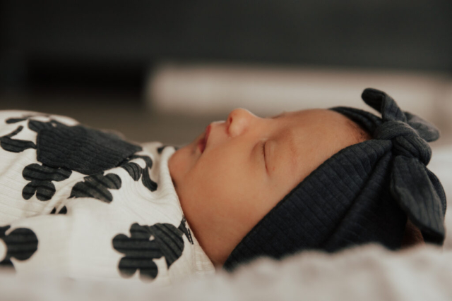 Details of a newborn baby’s face while being held by their parents. Photography by Dallas Photographer Hannah Lylene Photography