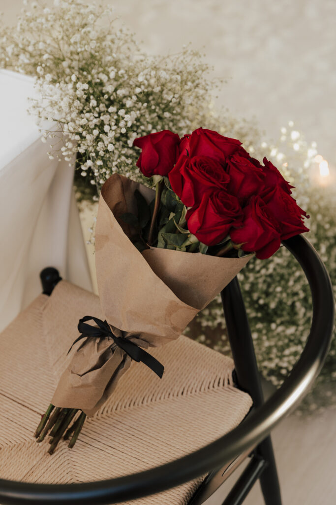 Details of an all white proposal set up, with baby&rsquo;s breath and candles at the Lumen Room studio in Fort Worth Texas.