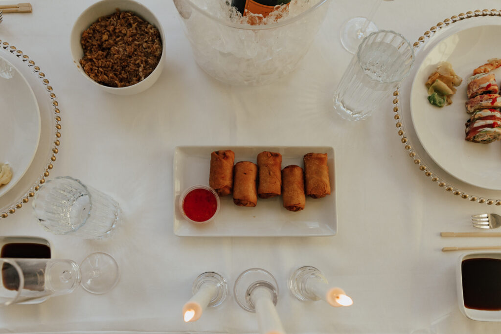 Details of an all white proposal set up, with baby&rsquo;s breath and candles at the Lumen Room studio in Fort Worth Texas.