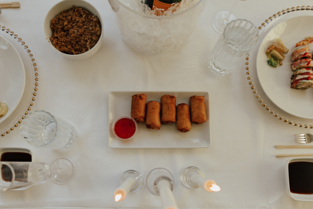 Details of an all white proposal set up, with baby’s breath and candles at the Lumen Room studio in Fort Worth Texas.