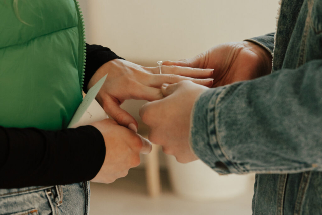 0N4A4984-For Web-2 A couple in neutral attire at the Lumen Room Studio in Fort Worth, Texas get engaged surrounded by baby’s breath. Photography by Hannah Lylene Photography.