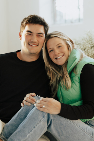 0N4A5136 A couple in neutral attire at the Lumen Room Studio in Fort Worth, Texas get engaged surrounded by baby’s breath. Photography by Hannah Lylene Photography.