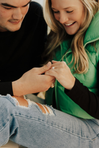0N4A5166 A couple in neutral attire at the Lumen Room Studio in Fort Worth, Texas get engaged surrounded by baby’s breath. Photography by Hannah Lylene Photography.