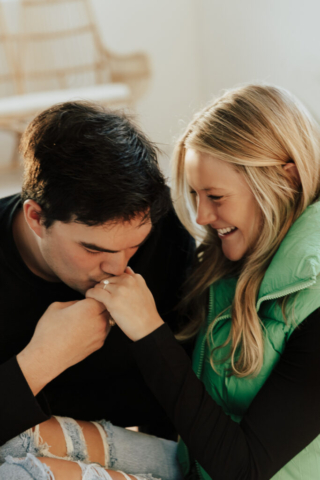 0N4A5176-Edit A couple in neutral attire at the Lumen Room Studio in Fort Worth, Texas get engaged surrounded by baby’s breath. Photography by Hannah Lylene Photography.