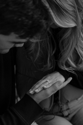 0N4A5287-For Web-2 A couple in neutral attire at the Lumen Room Studio in Fort Worth, Texas get engaged surrounded by baby’s breath. Photography by Hannah Lylene Photography.