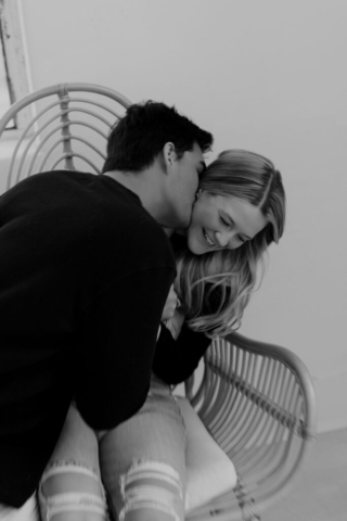 0N4A5332-For Web-2 A couple in neutral attire at the Lumen Room Studio in Fort Worth, Texas get engaged surrounded by baby’s breath. Photography by Hannah Lylene Photography.