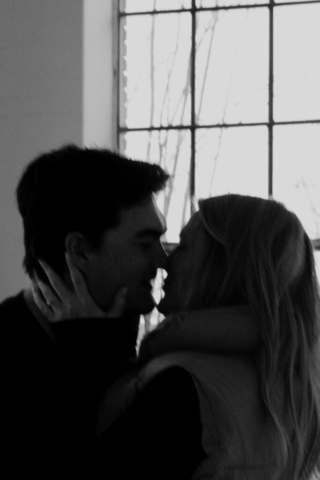 0N4A5439-For Web-2 A couple in neutral attire at the Lumen Room Studio in Fort Worth, Texas get engaged surrounded by baby’s breath. Photography by Hannah Lylene Photography.