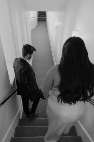 modern-classy-dfw-indoor-engagement A couple in neutral attire at Bass Hall kiss and run around for engagement photos.