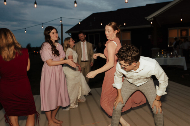 Outdoor-Flash-Intimate-Wedding-Reception Bride and Groom dance with their guests at their DFW Intimate Wedding Elopement
