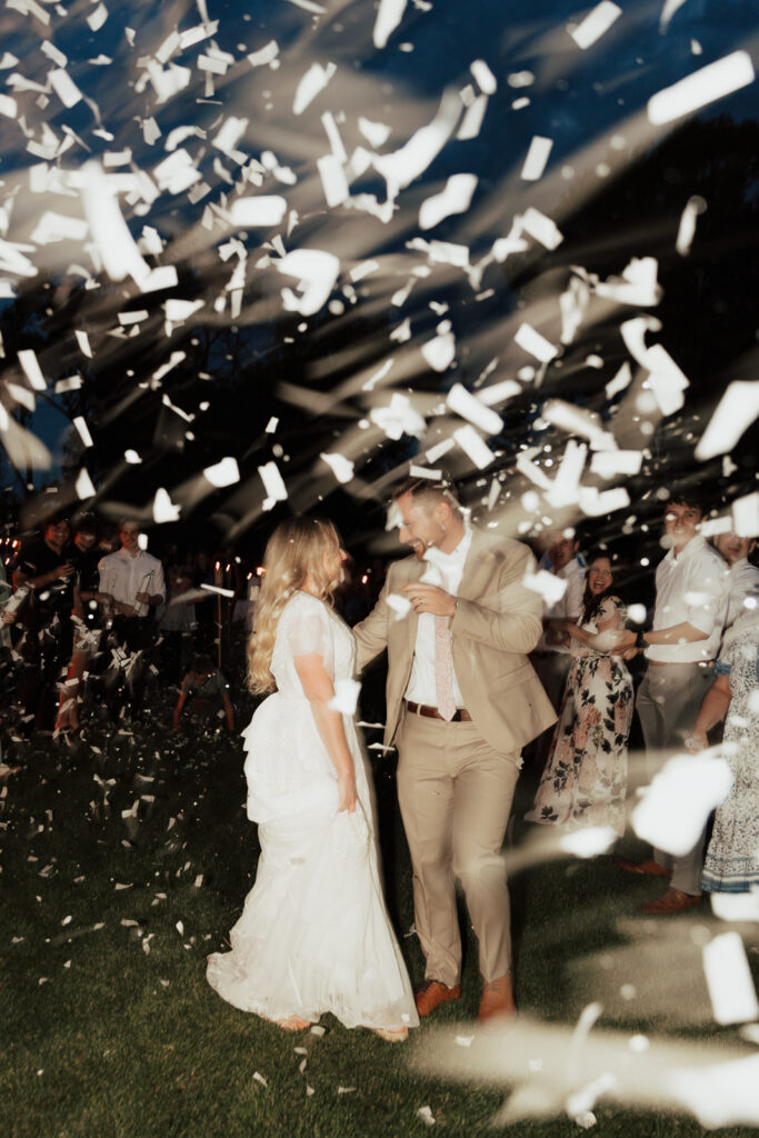 Bride and Groom during their confetti wedding exit from their DFW Intimate Wedding Elopement
