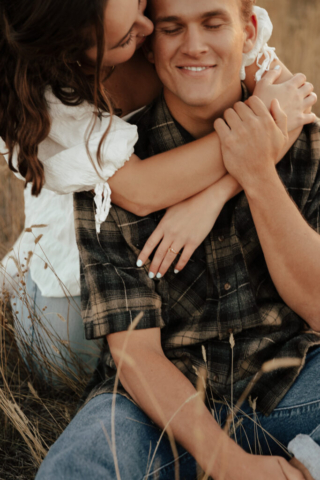 Close up shot of a young girl hugging a man from behind