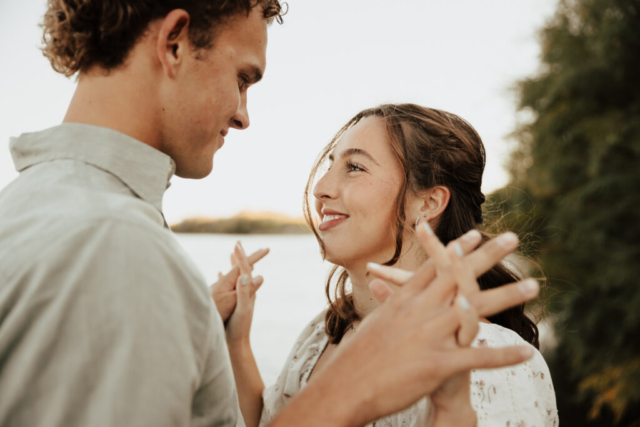 A young couple holds hands lakeside at Grapevine Lake