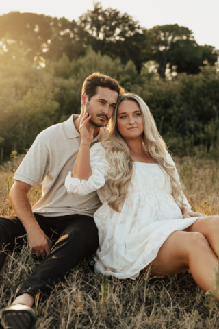 A couple in neutral attire at Grapevine Lake take candid engagement photos.