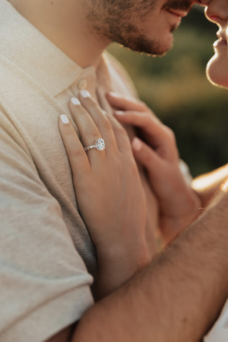 A couple in neutral attire at Grapevine Lake take candid engagement photos.