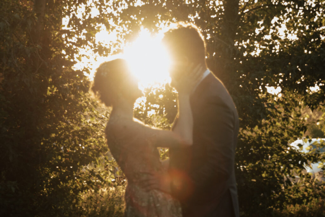 A bride in a gold dress and her groom
