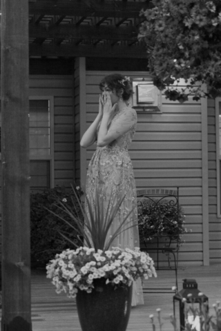 Black and white image of a young bride crying during her wedding speeches
