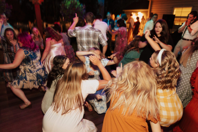 Outdoor backyard wedding ceremony dance party with night time flash photography