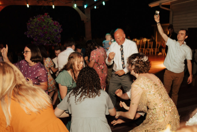 Outdoor backyard wedding ceremony dance party with night time flash photography