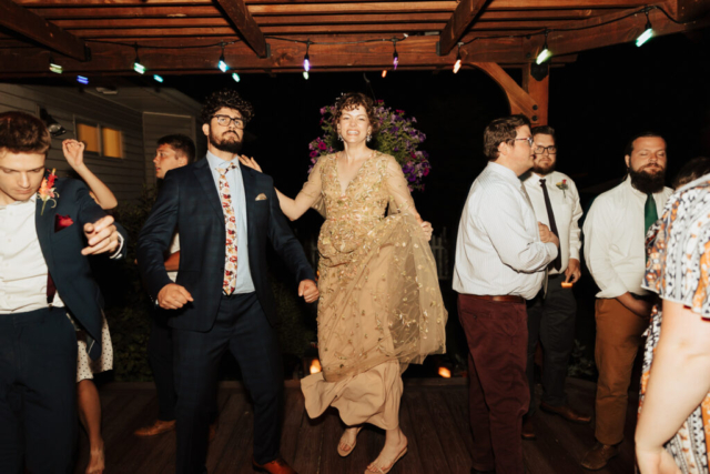 Outdoor backyard wedding ceremony dance reception with night time flash photography