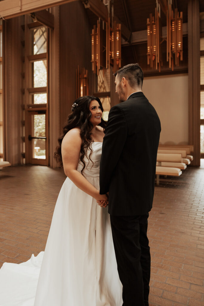 A young bride and groom at Marty Leonard Chapel on their intimate wedding day in Fort Worth, Texas.