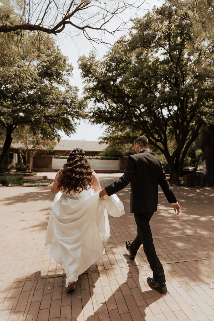 A young bride and groom at Marty Leonard Chapel on their intimate wedding day in Fort Worth, Texas.