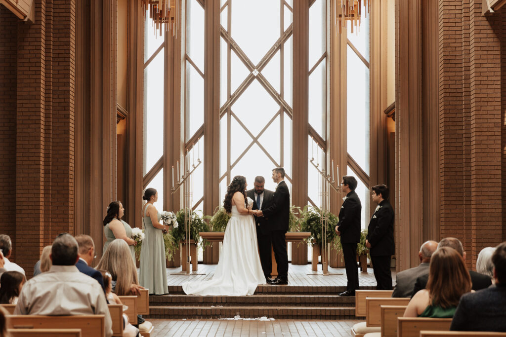 A young bride and groom at Marty Leonard Chapel on their intimate wedding day in Fort Worth, Texas.