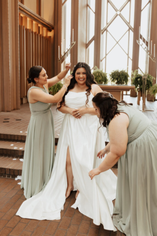 bridemaids-group-shot-candid A young bride and groom at Marty Leonard Chapel on their intimate wedding day in Fort Worth, Texas.