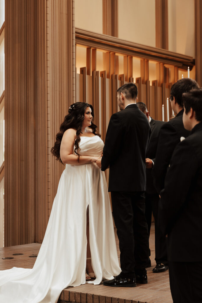 A young bride and groom at Marty Leonard Chapel on their intimate wedding day in Fort Worth, Texas.