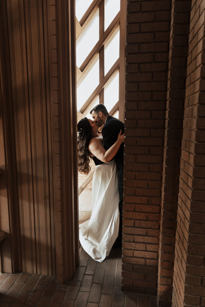 A young bride and groom at Marty Leonard Chapel on their intimate wedding day in Fort Worth, Texas.