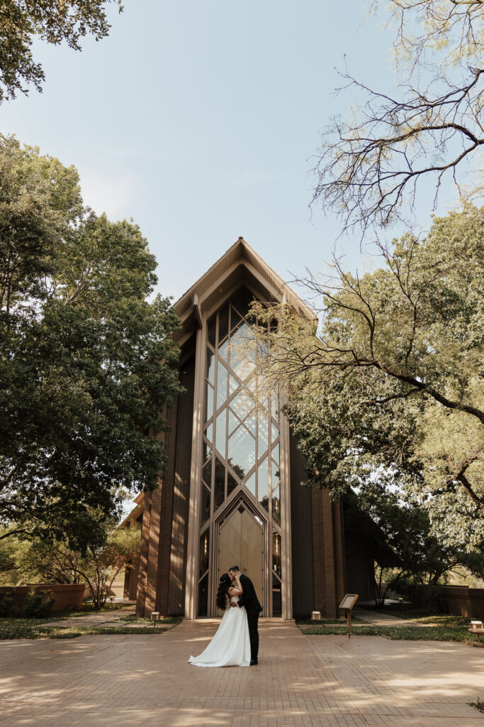 A young bride and groom at Marty Leonard Chapel on their intimate wedding day in Fort Worth, Texas.
