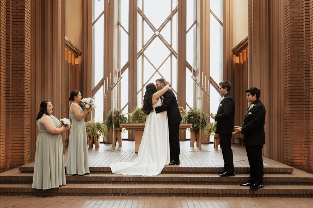 A young bride and groom at Marty Leonard Chapel on their intimate wedding day in Fort Worth, Texas.