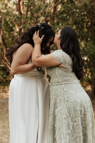 mother-daughter-wedding-pose A young bride and groom at Marty Leonard Chapel on their intimate wedding day in Fort Worth, Texas.