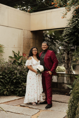 A bride and groom in their wedding attire on their wedding day take their romantic and natural documentary styled photos at the Dallas Arboretum.