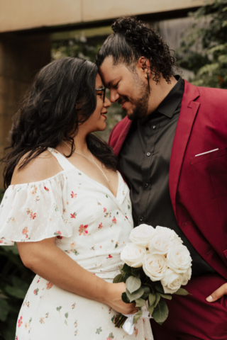 A bride and groom in their wedding attire on their wedding day take their romantic and natural documentary styled photos at the Dallas Arboretum.
