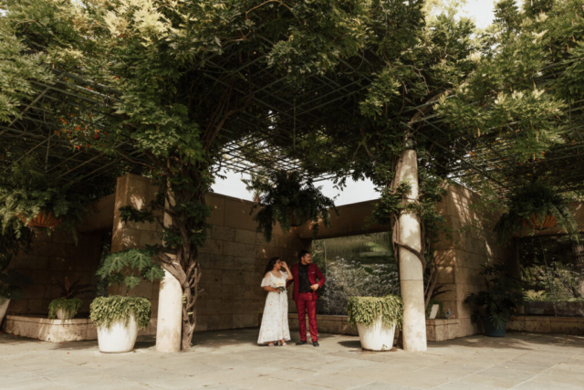 A bride and groom in their wedding attire on their wedding day take their romantic and natural documentary styled photos at the Dallas Arboretum.