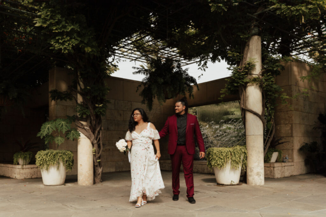A bride and groom in their wedding attire on their wedding day take their romantic and natural documentary styled photos at the Dallas Arboretum.