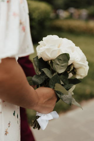 A bride and groom in their wedding attire on their wedding day take their romantic and natural documentary styled photos at the Dallas Arboretum.