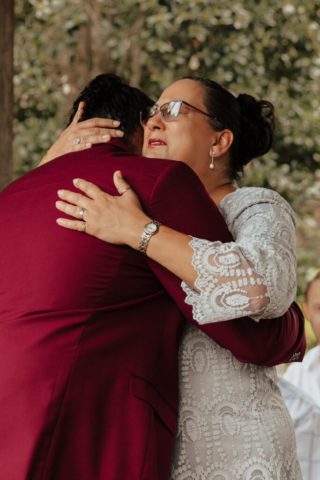 A bride and groom in their wedding attire on their wedding day take their romantic and natural documentary styled photos at the Dallas Arboretum.