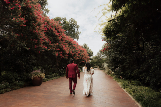 A bride and groom in their wedding attire on their wedding day take their romantic and natural documentary styled photos at the Dallas Arboretum.