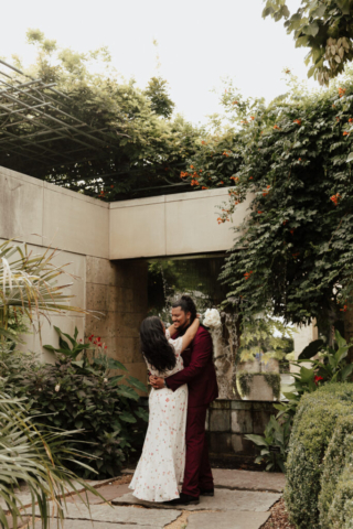 A bride and groom in their wedding attire on their wedding day take their romantic and natural documentary styled photos at the Dallas Arboretum.