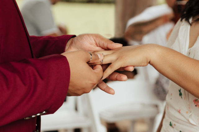 A bride and groom in their wedding attire on their wedding day take their romantic and natural documentary styled photos at the Dallas Arboretum.