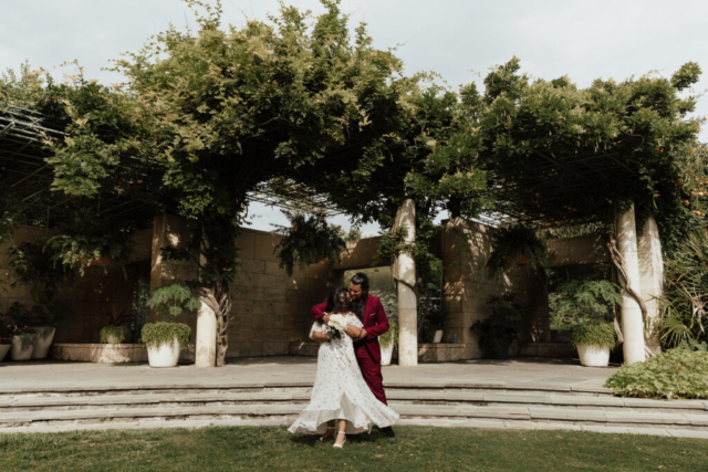 A bride and groom in their wedding attire on their wedding day take their romantic and natural documentary styled photos at the Dallas Arboretum.