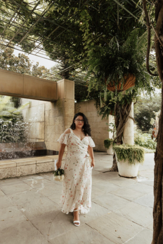 A bride and groom in their wedding attire on their wedding day take their romantic and natural documentary styled photos at the Dallas Arboretum.