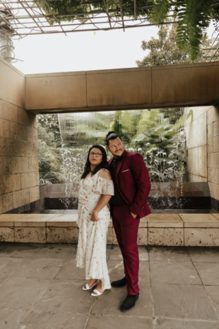A bride and groom in their wedding attire on their wedding day take their romantic and natural documentary styled photos at the Dallas Arboretum.