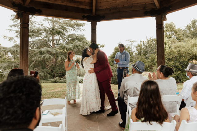 A bride and groom in their wedding attire on their wedding day take their romantic and natural documentary styled photos at the Dallas Arboretum.