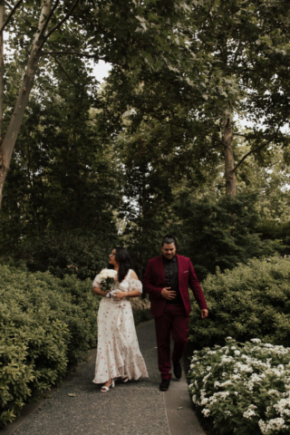 A bride and groom in their wedding attire on their wedding day take their romantic and natural documentary styled photos at the Dallas Arboretum.