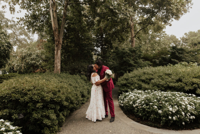 A bride and groom in their wedding attire on their wedding day take their romantic and natural documentary styled photos at the Dallas Arboretum.